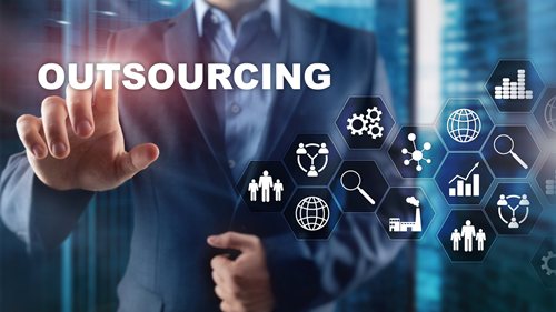 hand pointing to text that says 'outsourcing'. 