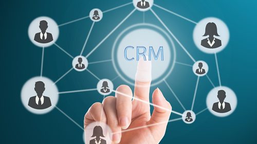 Finger pointing to text saying 'CRM'.