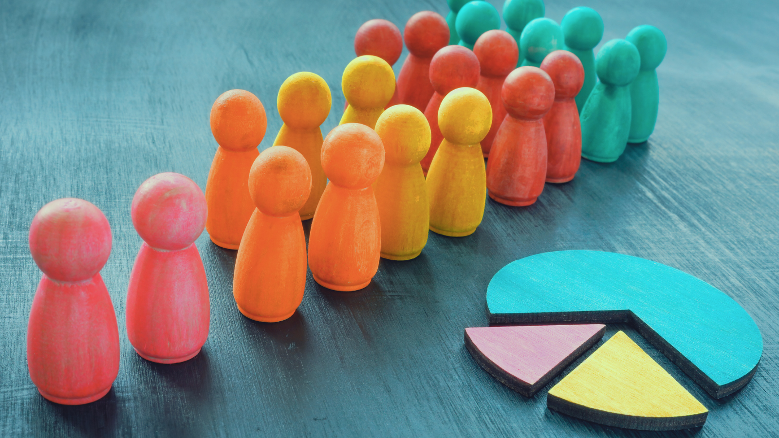 A chart and different coloured stopper resembling people. Colours include pink, orange, yellow, red and blue.