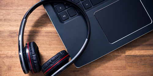 Laptop with headphone on it.