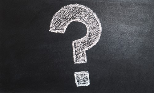A chalkboard with a question mark drawn on in chalk.