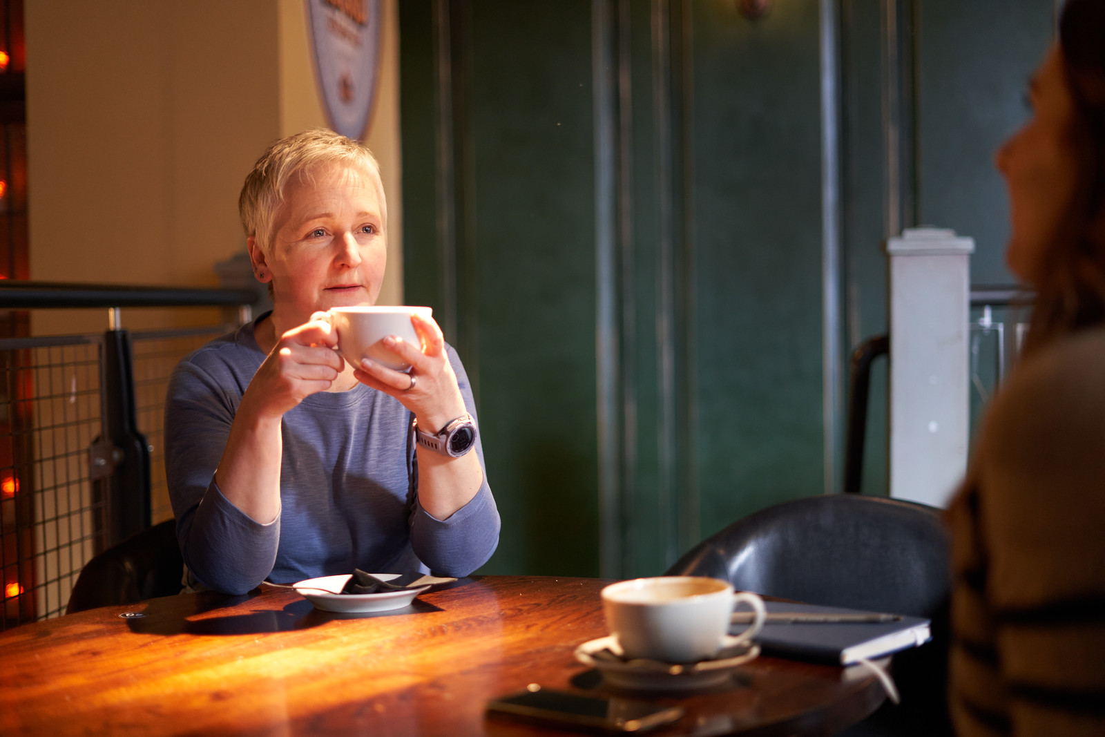 Alison holding a cup.