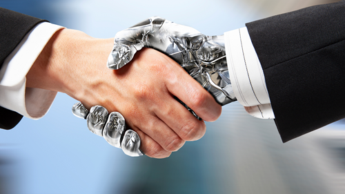 Human and robot shaking hands.