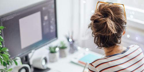 Woman sat in front of computer.